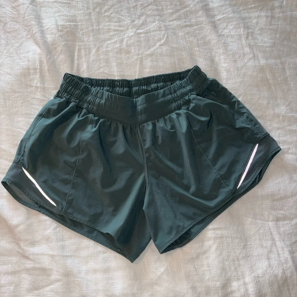 lululemon athletica dark green athletic shorts with reflective accents